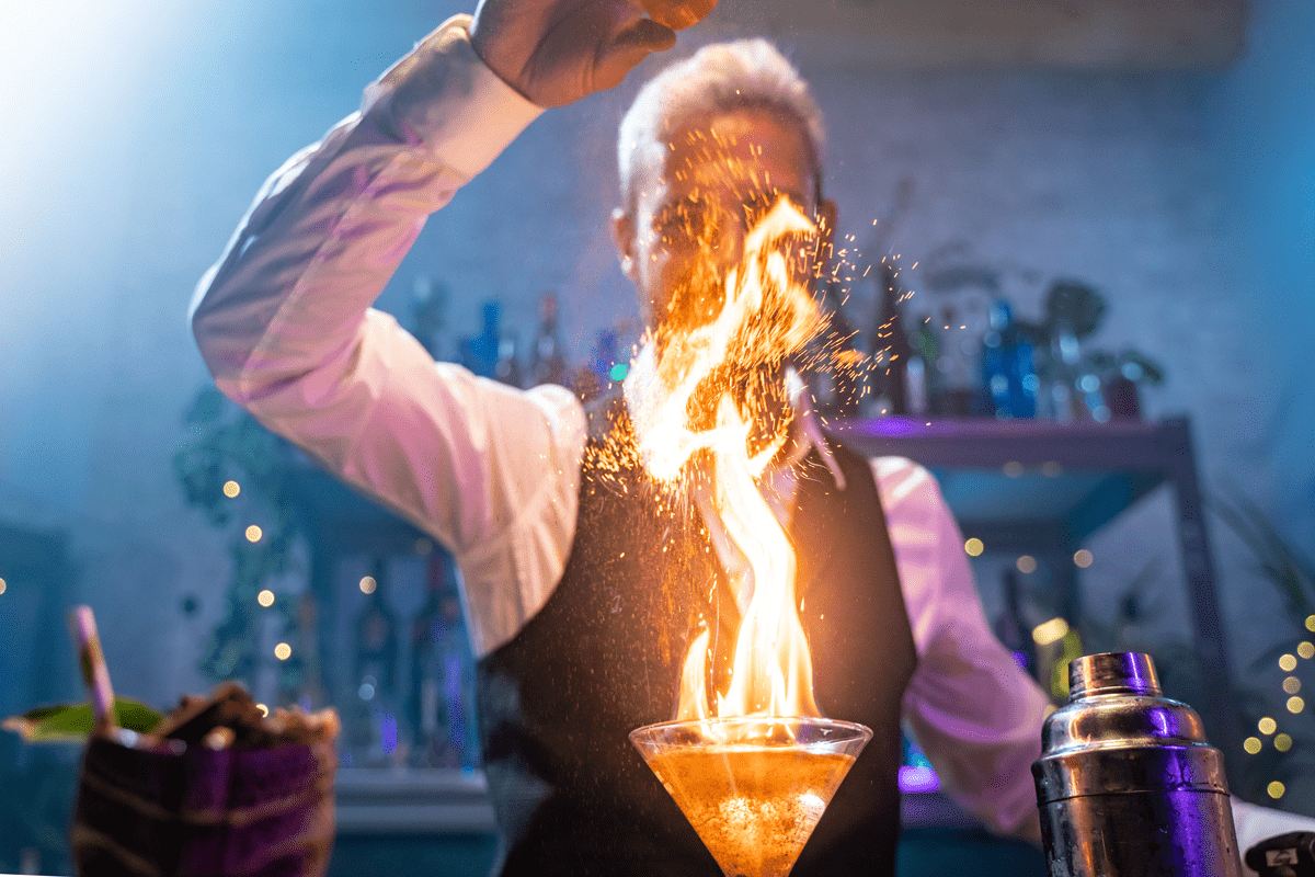 bartender-making-a-cocktail-with-fire-flame-unique-2022-11-11-03-19-06-utc-min