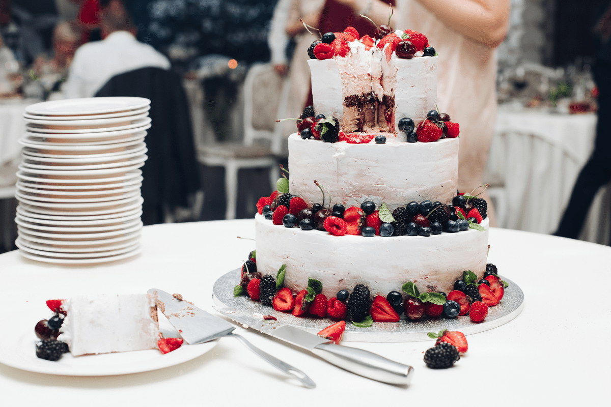 beautiful-wedding-cake-with-berries-sliced-wedding-2021-09-03-06-34-47-utc-min