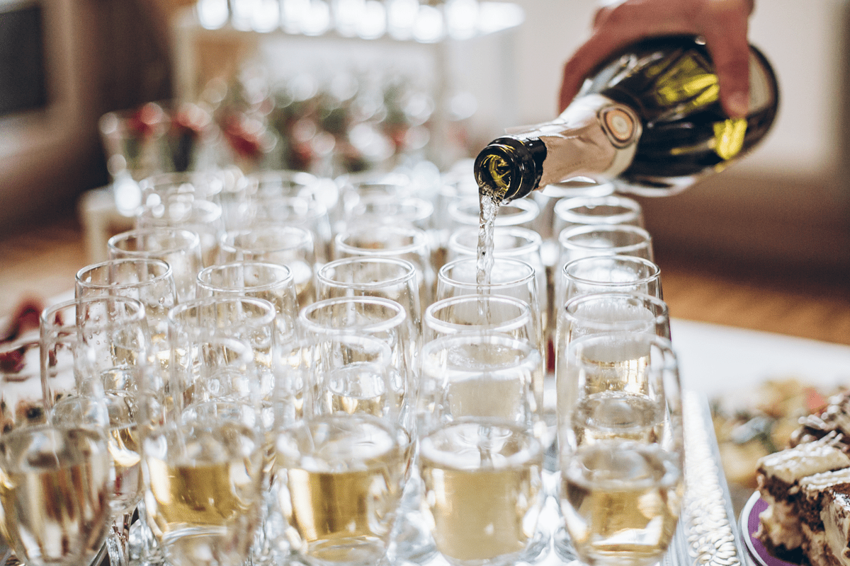 waiter-pouring-champagne-in-stylish-glasses-at-lux-2022-02-02-03-59-28-utc-min