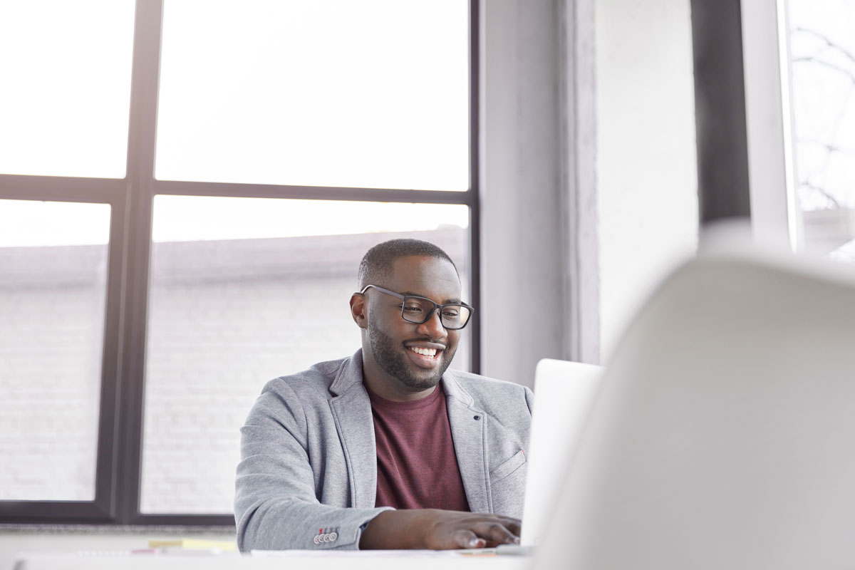 glad-black-man-manager-keyboards-on-laptop-compute-2021-08-31-07-10-36-utc-min