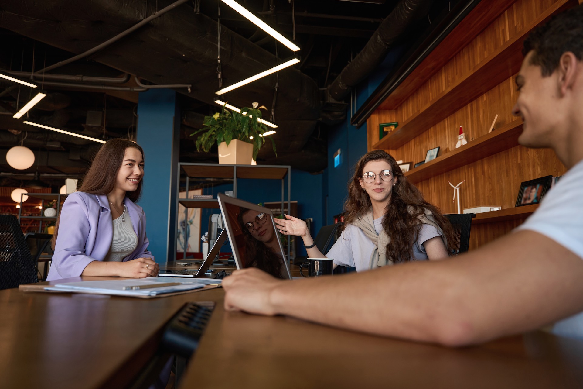 friendly-office-team-discussing-workflow-at-a-tabl-2023-11-27-05-29-32-utc